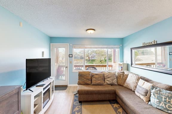 Creekside condo with beach access balcony full kitchen and ocean views - Image 1